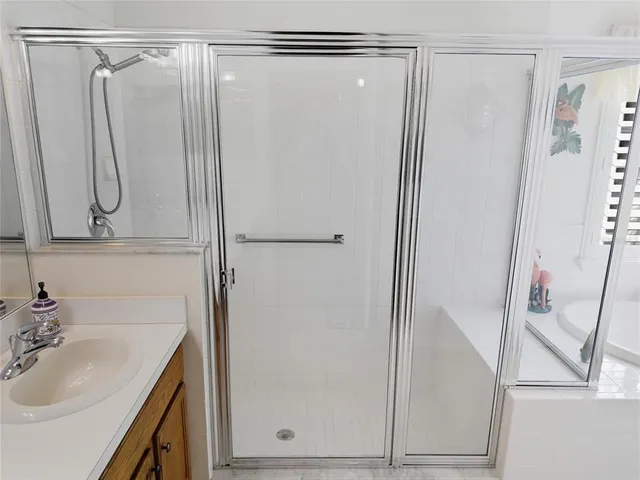 a bedroom with two beds and a chandelier