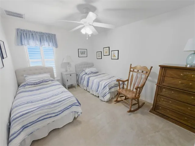 a bedroom with a bed and a flat tv screen on the dresser