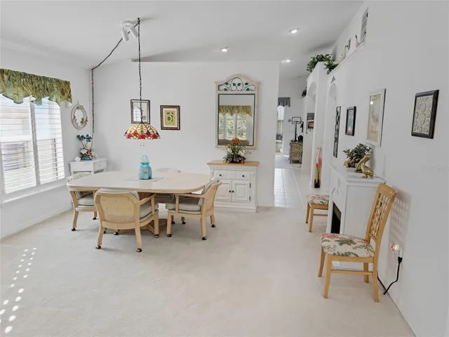 a view of a dining room with furniture and a window