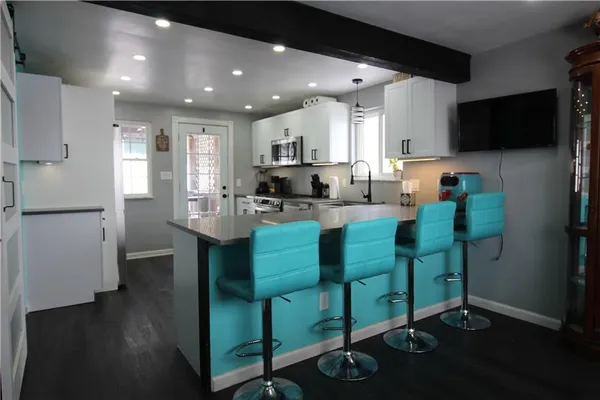 a kitchen with cabinets a sink and appliances