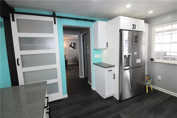 a kitchen with a refrigerator and a sink