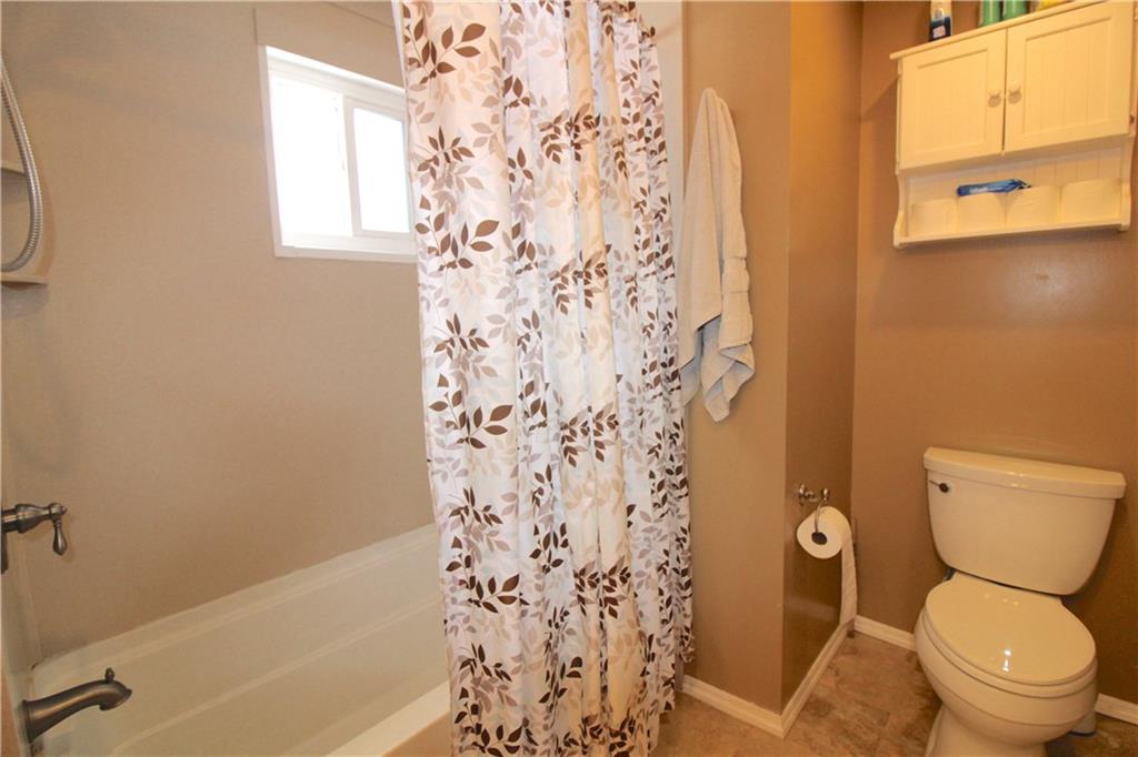 5877 Pleasant Street South Park, PA 15129 - Photo 22 of 34 a white toilet sitting next to a bath tub and a shower curtain