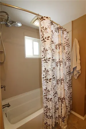 a bathroom with a shower curtain and a bathtub