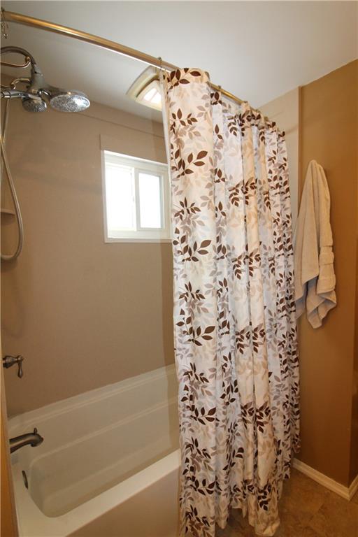 5877 Pleasant Street South Park, PA 15129 - Photo 23 of 34 a bathroom with a shower curtain and a bathtub