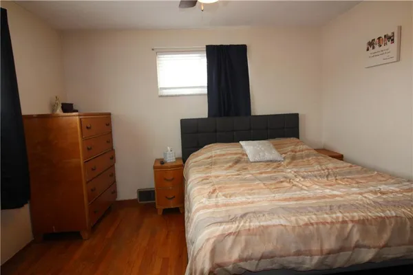 a bed sitting in a bedroom next to a window