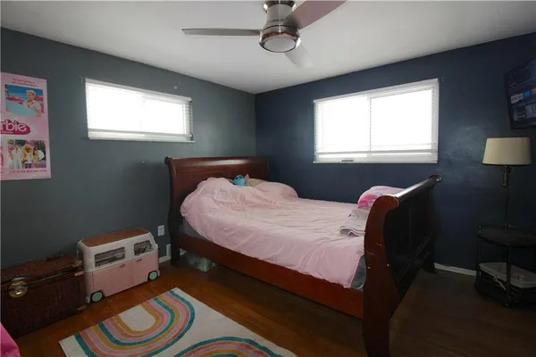 a bed room with a bed and a chair