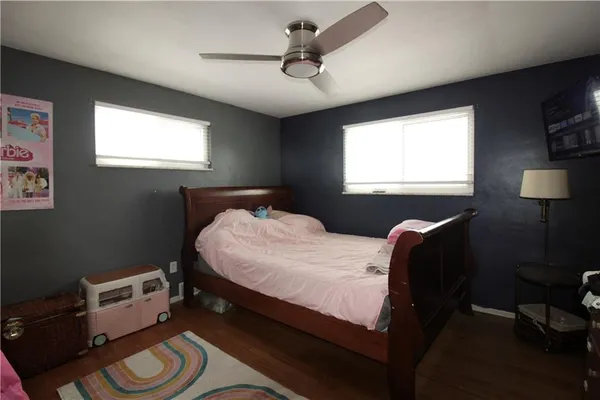 a bed sitting in a bedroom next to a window