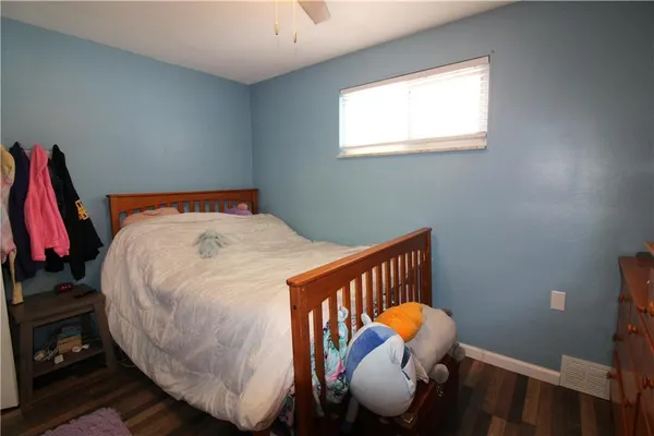 a bed sitting in a bedroom next to a window