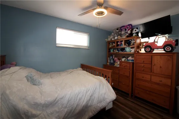 a bedroom with a bed and flat screen tv