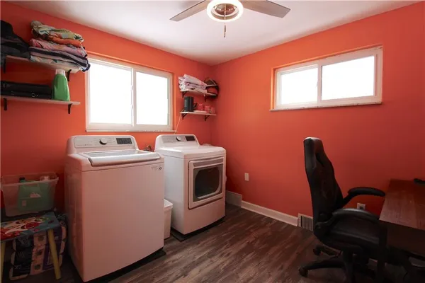 a utility room with dryer washer and a window