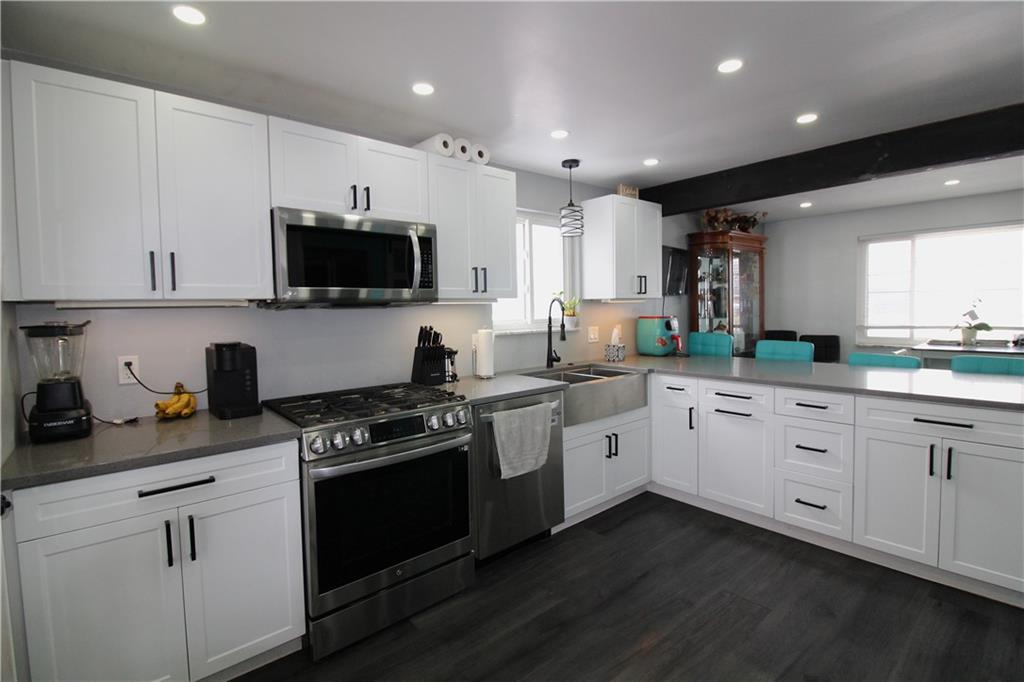 5877 Pleasant Street South Park, PA 15129 - Photo 4 of 34 a kitchen with granite countertop white cabinets and white appliances
