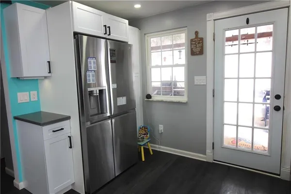 a kitchen with stainless steel appliances a refrigerator and a window