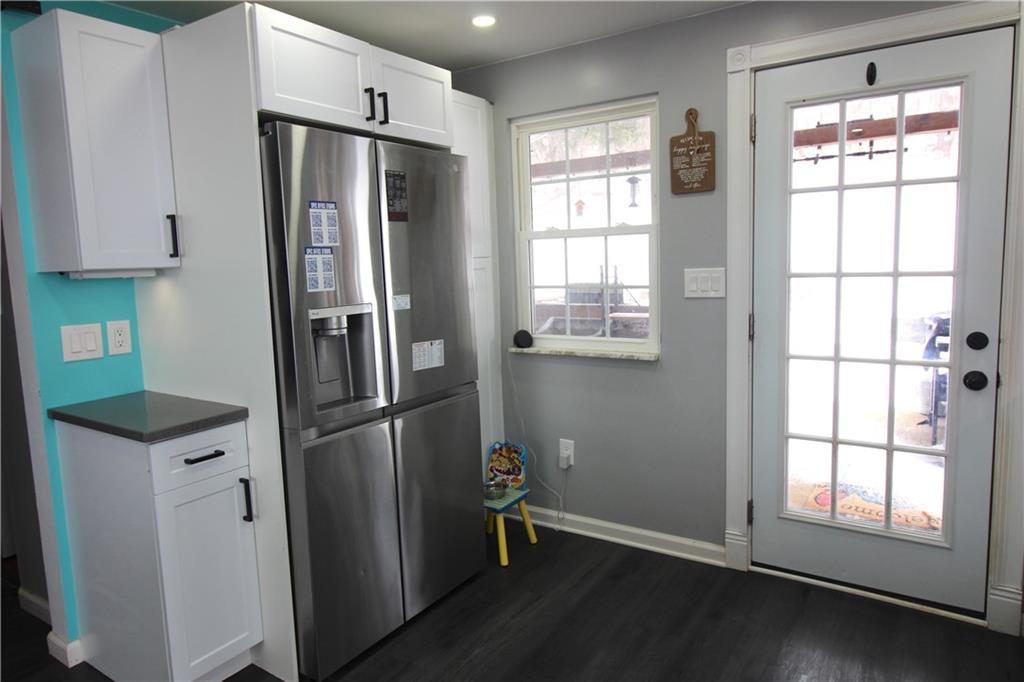 5877 Pleasant Street South Park, PA 15129 - Photo 8 of 34 a kitchen with stainless steel appliances a refrigerator and a window