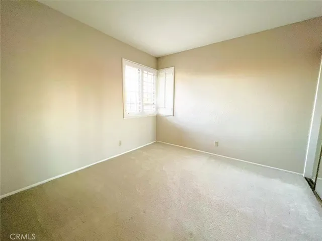 a bathroom with a granite countertop toilet sink and mirror