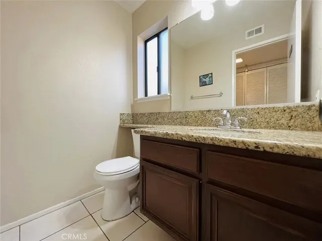 a yellow and red house sitting in middle of the grass