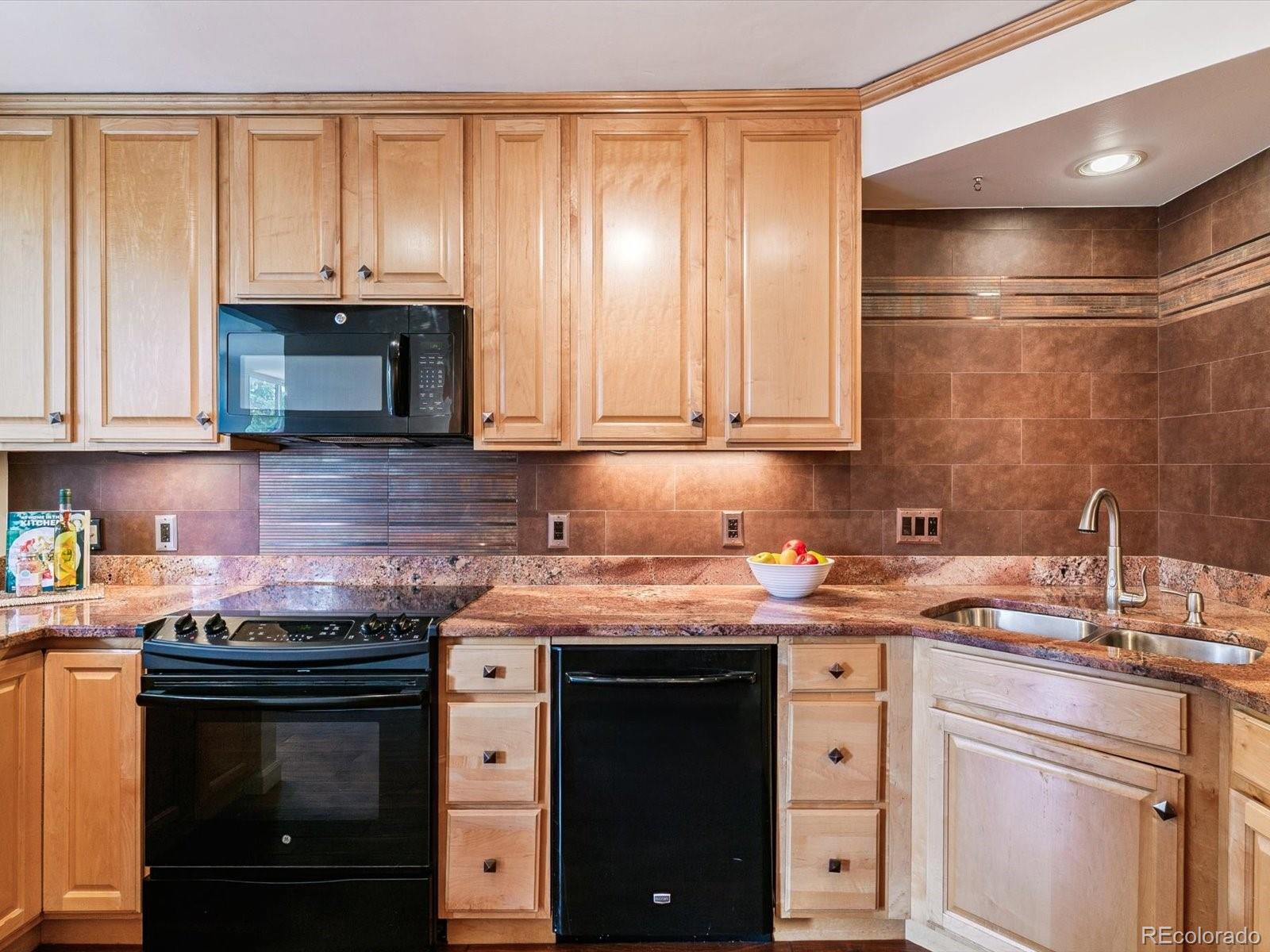 1111 Race Street, Unit 3A Denver, CO 80206 - Photo 13 of 39 a kitchen with stainless steel appliances granite countertop a sink stove and cabinets