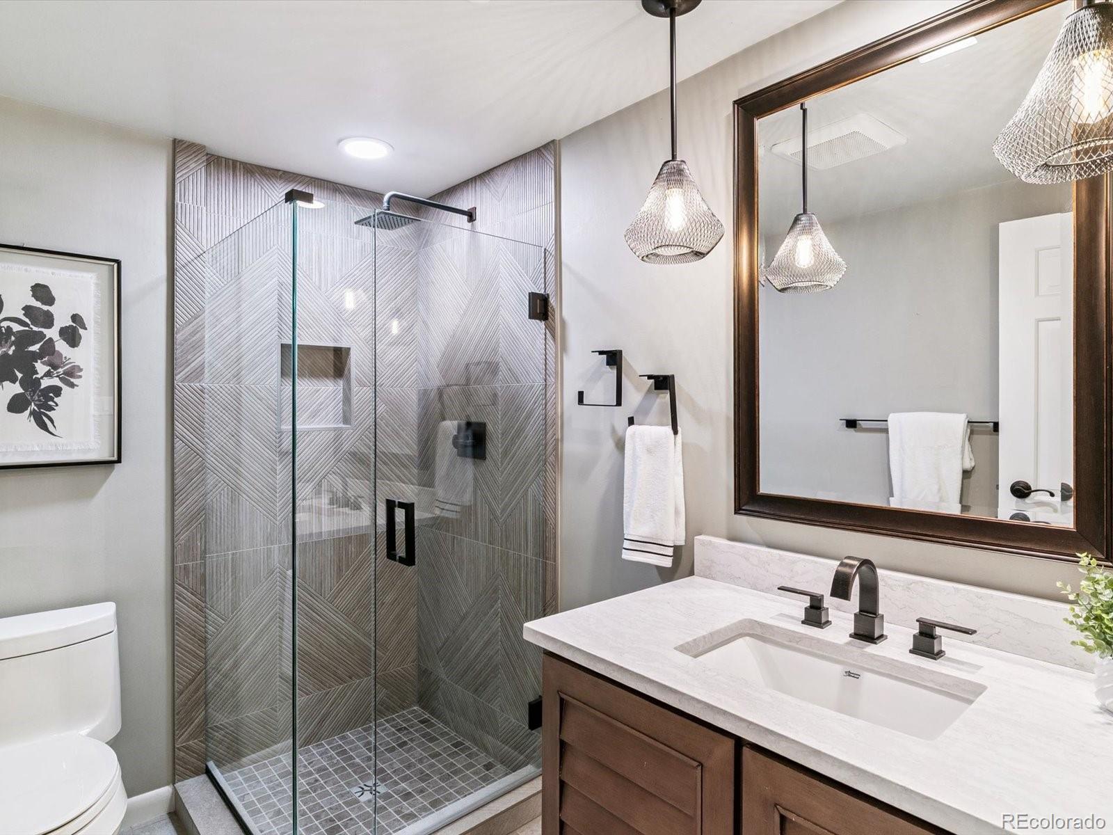 1111 Race Street, Unit 3A Denver, CO 80206 - Photo 16 of 39 a bathroom with a sink a toilet and shower