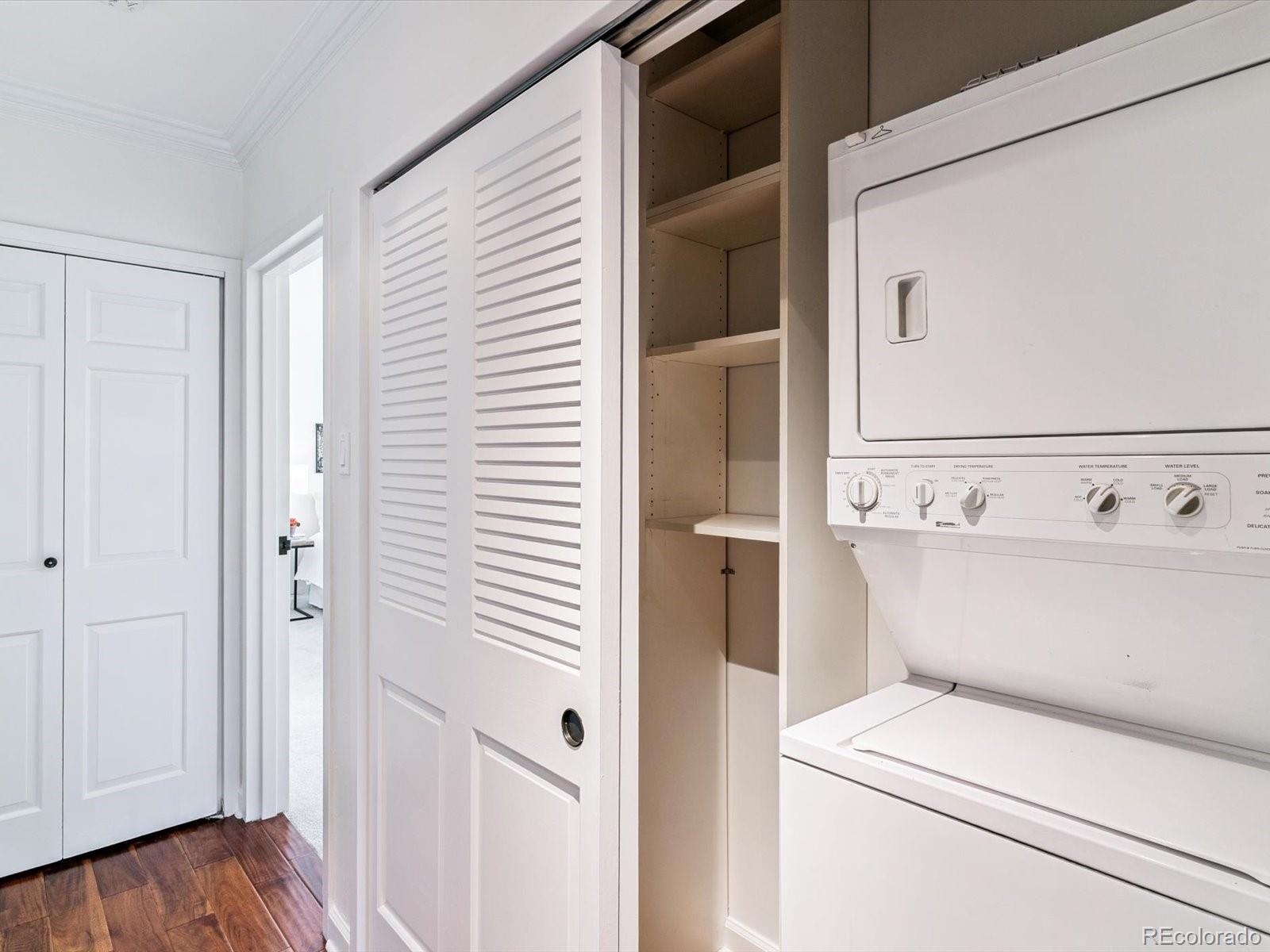 1111 Race Street, Unit 3A Denver, CO 80206 - Photo 17 of 39 a view of washer and dryer with bathroom in the background