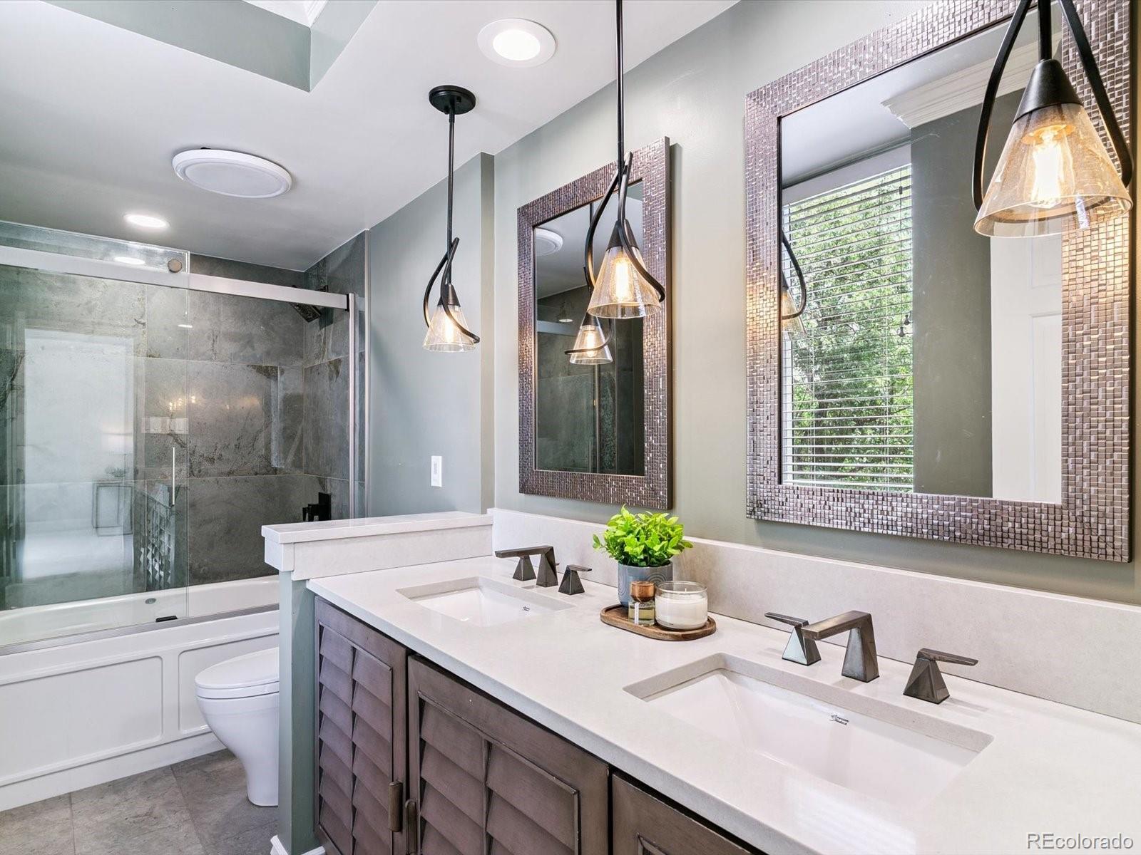 1111 Race Street, Unit 3A Denver, CO 80206 - Photo 20 of 39 a bathroom with a granite countertop sink toilet and shower