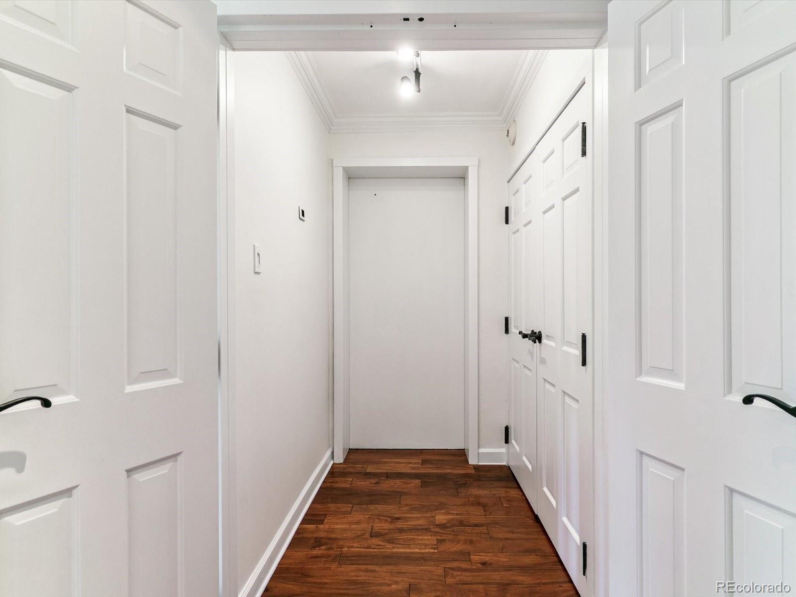 1111 Race Street, Unit 3A Denver, CO 80206 - Photo 5 of 39 a view of a hallway with a wooden door