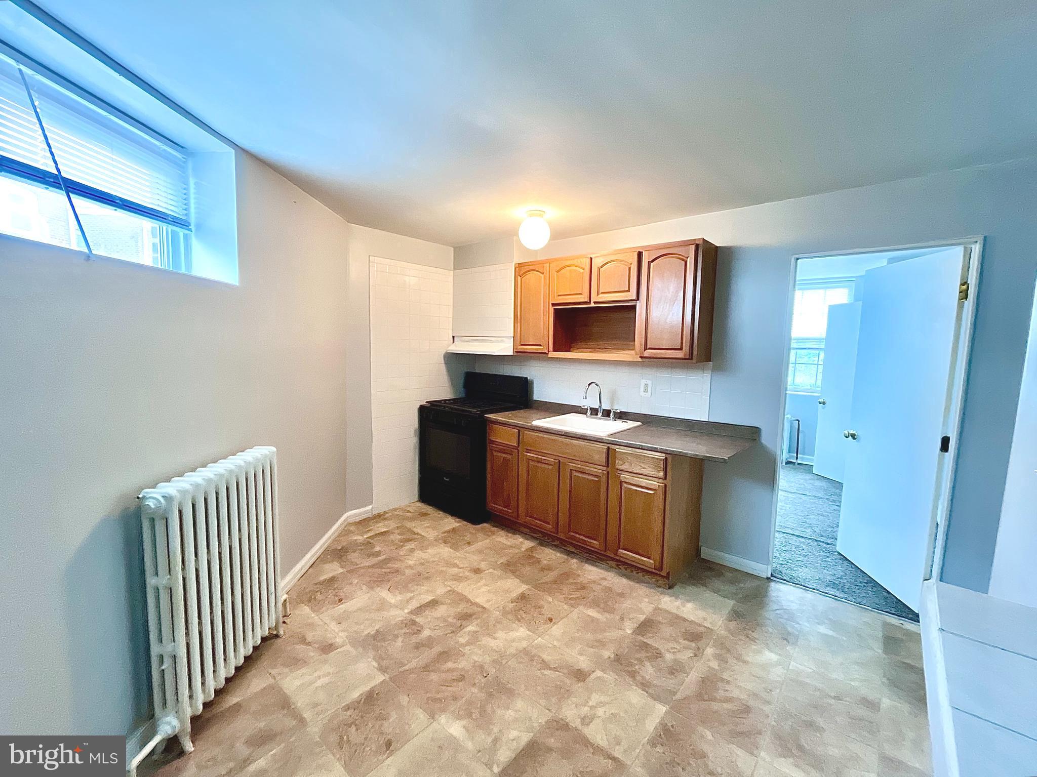 5615 Upland Way, Unit 1 Philadelphia, PA 19131 - Photo 4 of 10 a kitchen with stainless steel appliances a microwave sink and cabinets