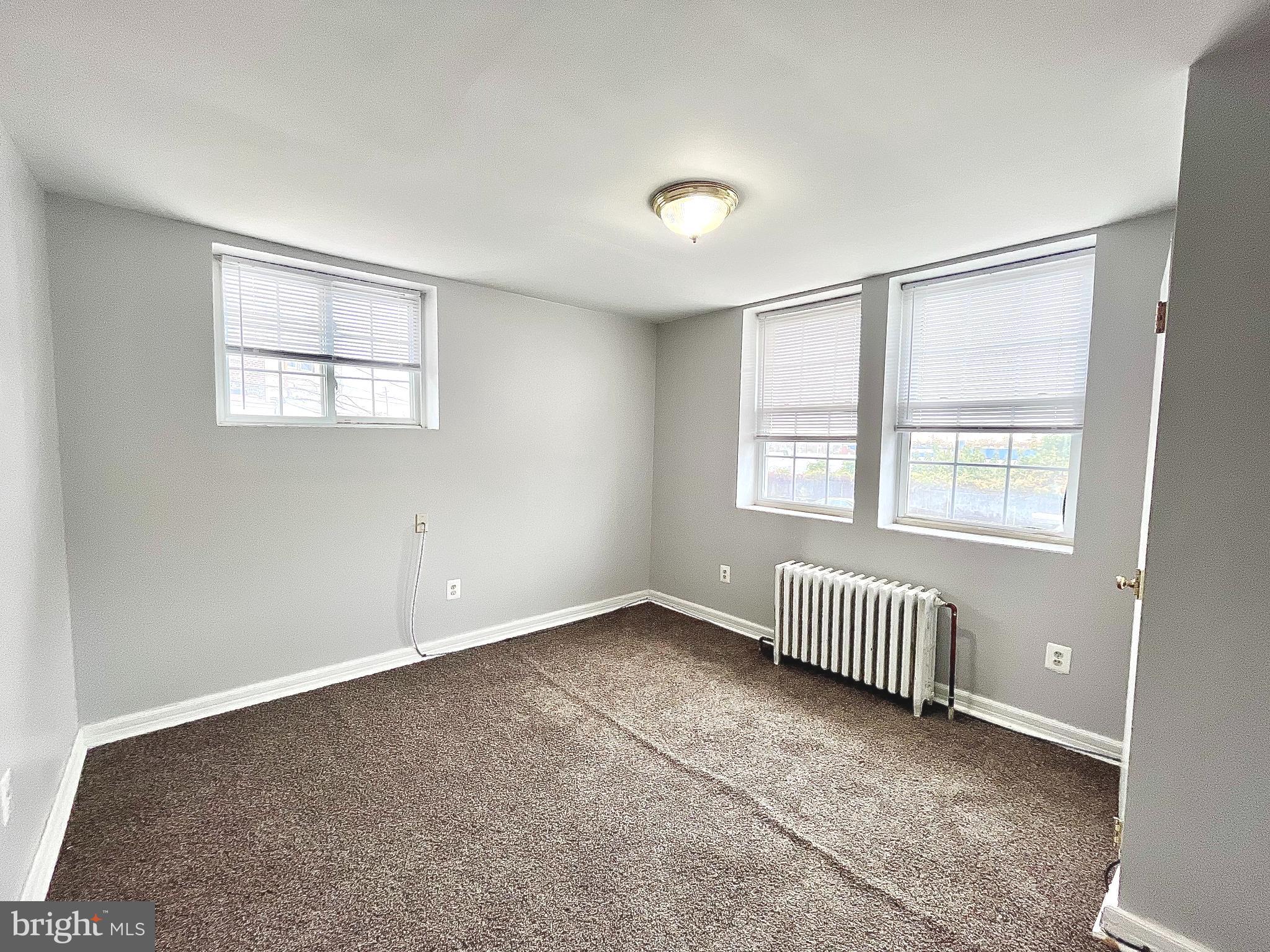 5615 Upland Way, Unit 1 Philadelphia, PA 19131 - Photo 7 of 10 an empty room with windows