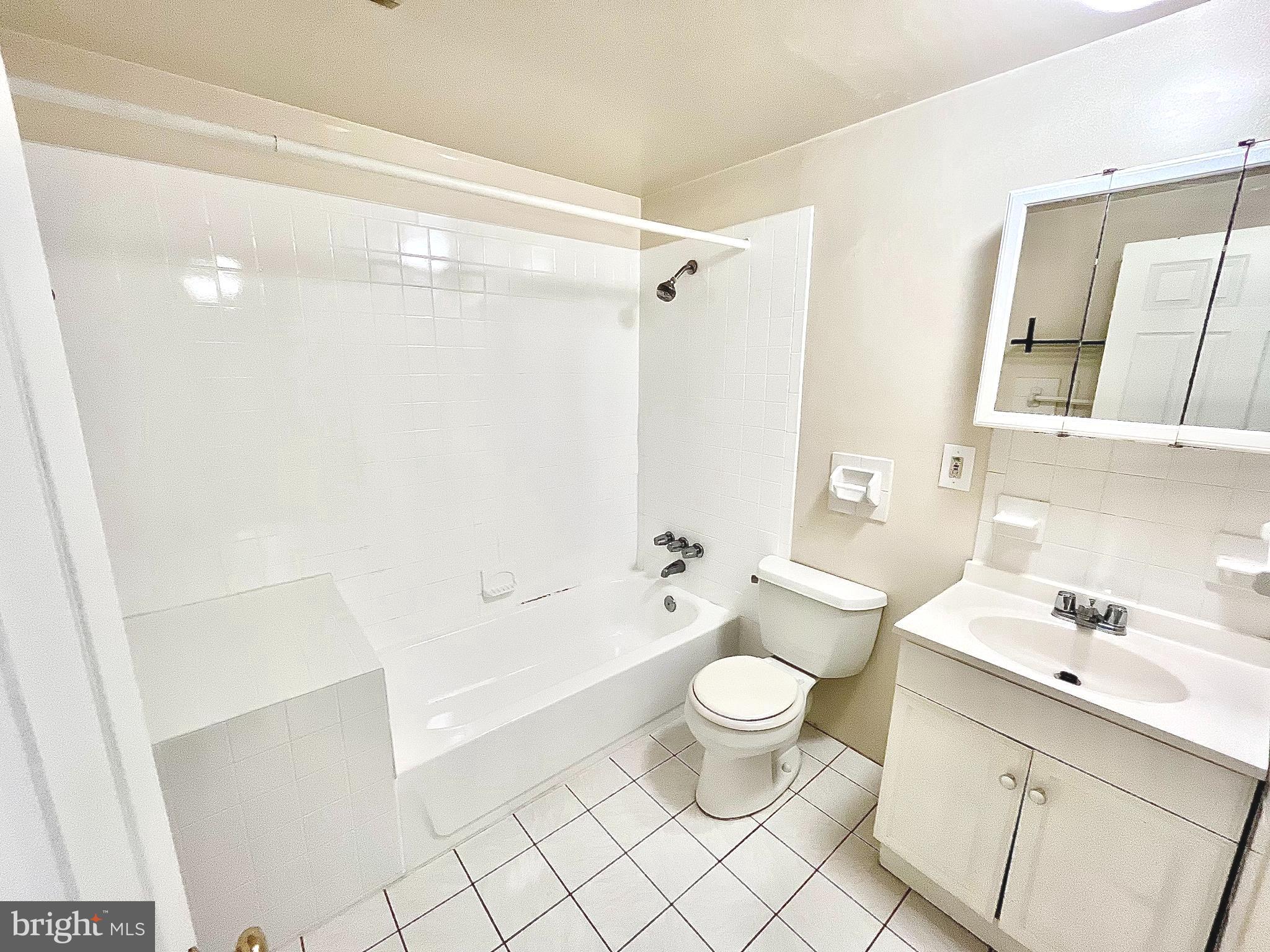 5615 Upland Way, Unit 1 Philadelphia, PA 19131 - Photo 8 of 10 a bathroom with a bathtub shower sink vanity and toilet