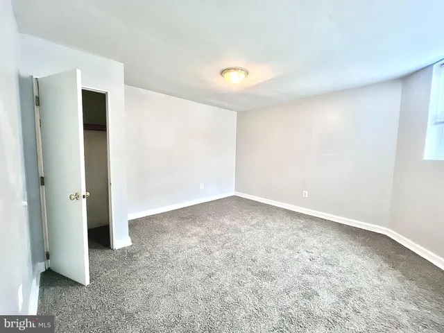 an empty room with windows and closet