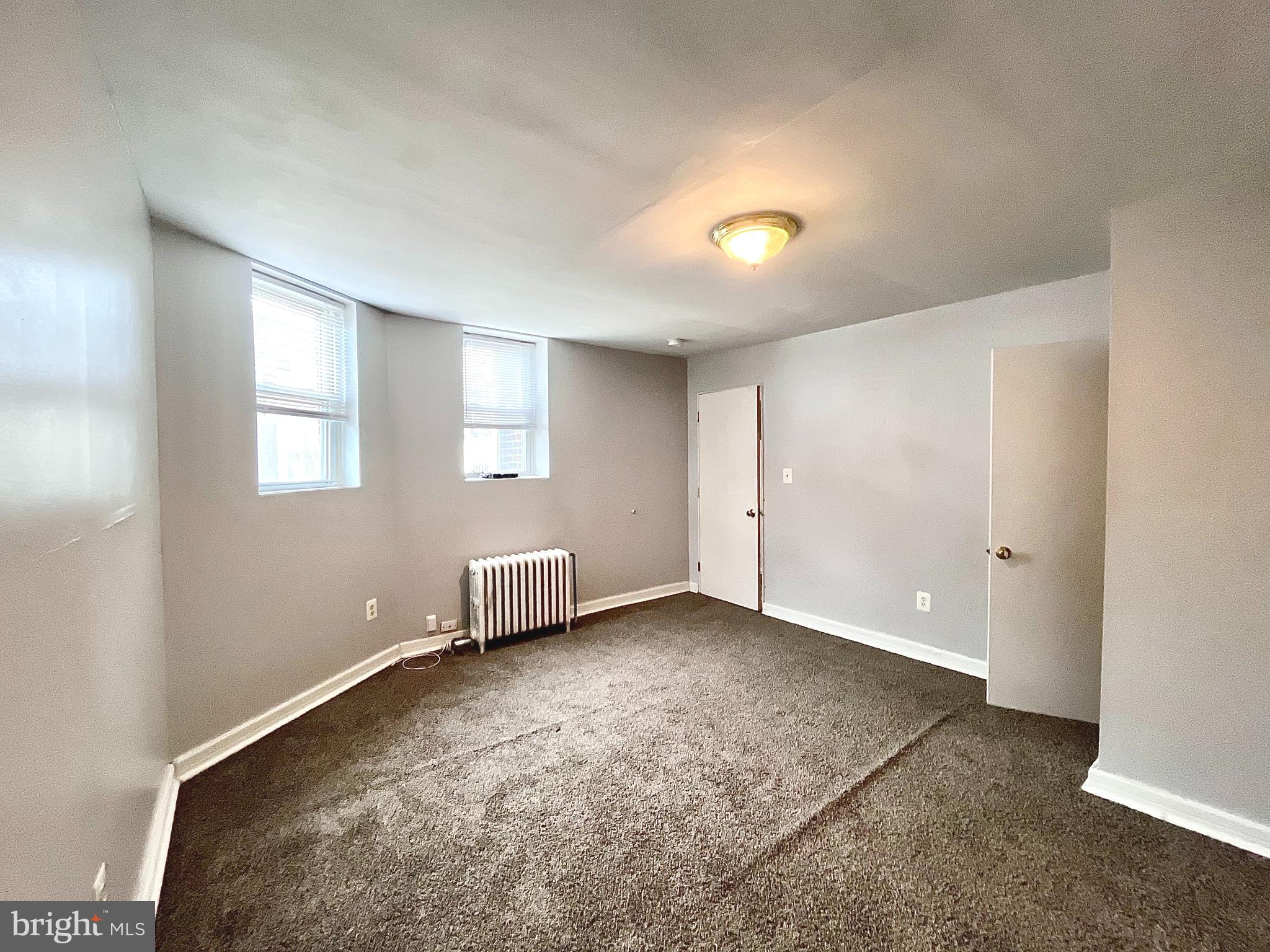 5615 Upland Way, Unit 1 Philadelphia, PA 19131 - Photo 10 of 10 an empty room with windows and closet