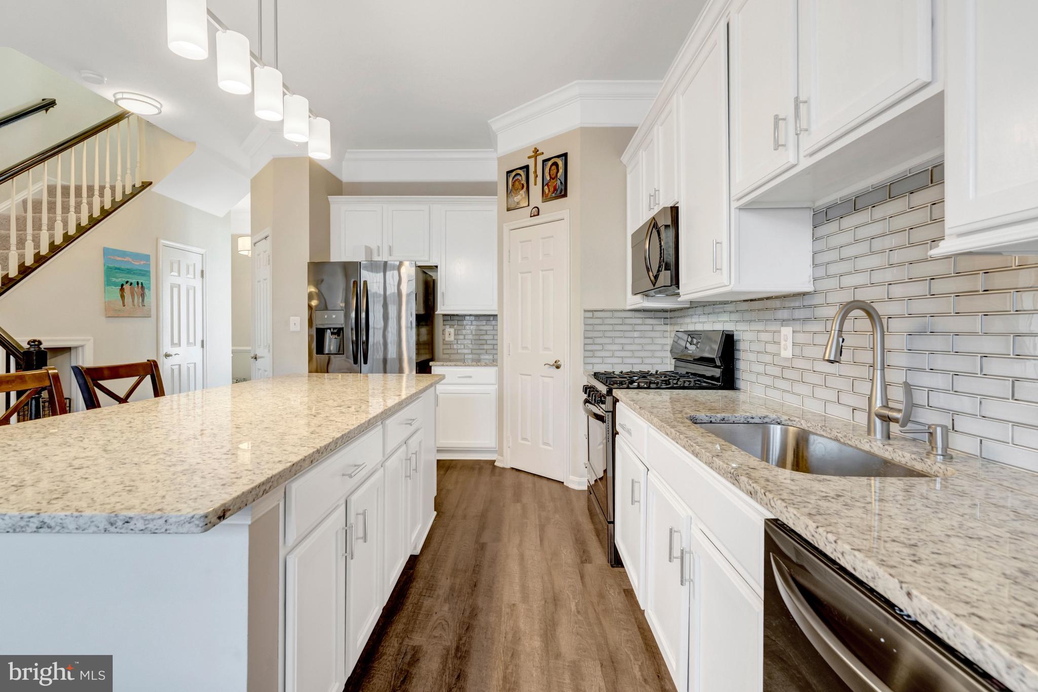 43546 Mink Meadows Street Chantilly, VA 20152 - Photo 11 of 48 a kitchen with stainless steel appliances granite countertop a sink and dishwasher