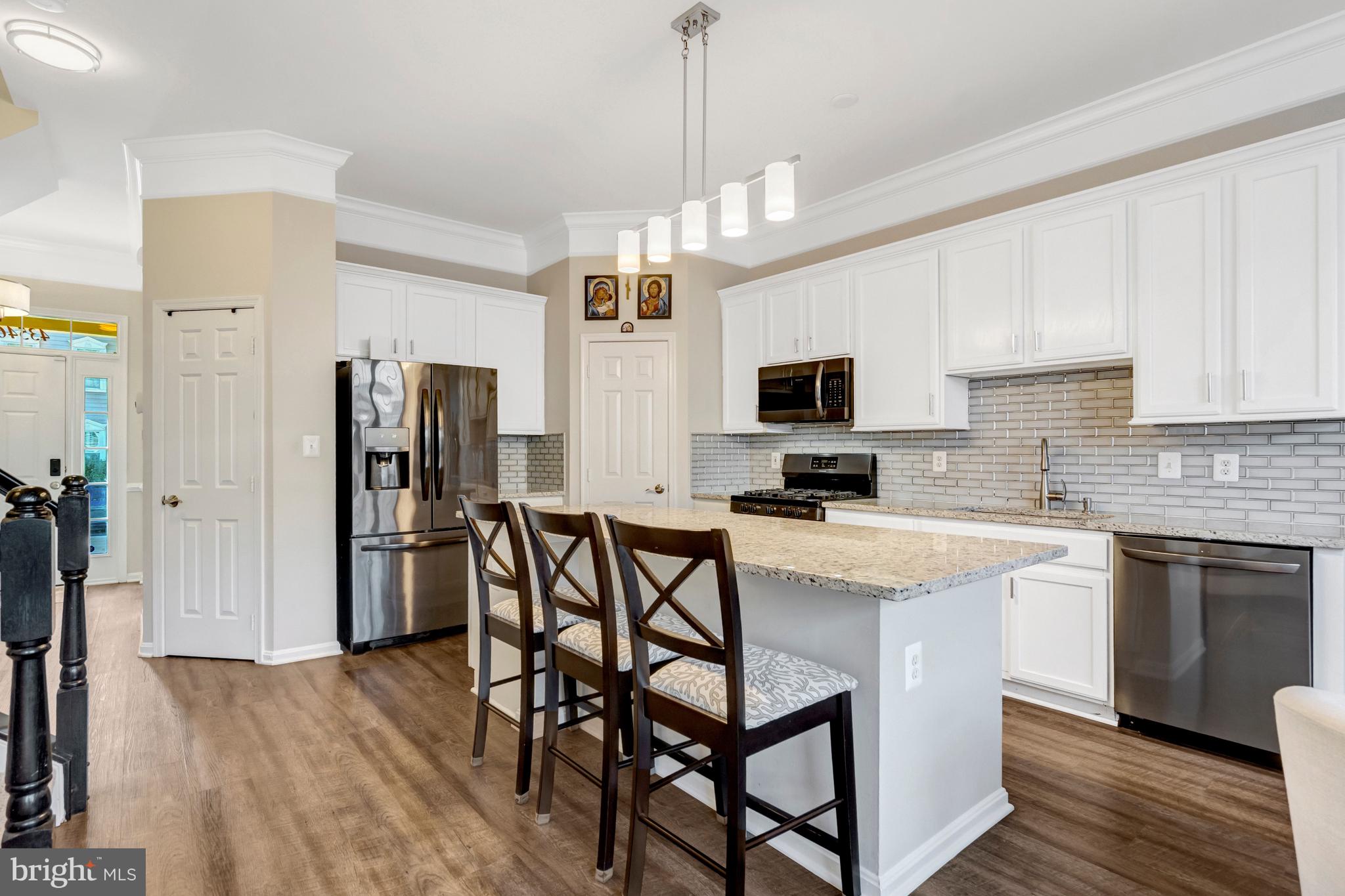 43546 Mink Meadows Street Chantilly, VA 20152 - Photo 12 of 48 a kitchen that has a lot of cabinets a sink and appliances