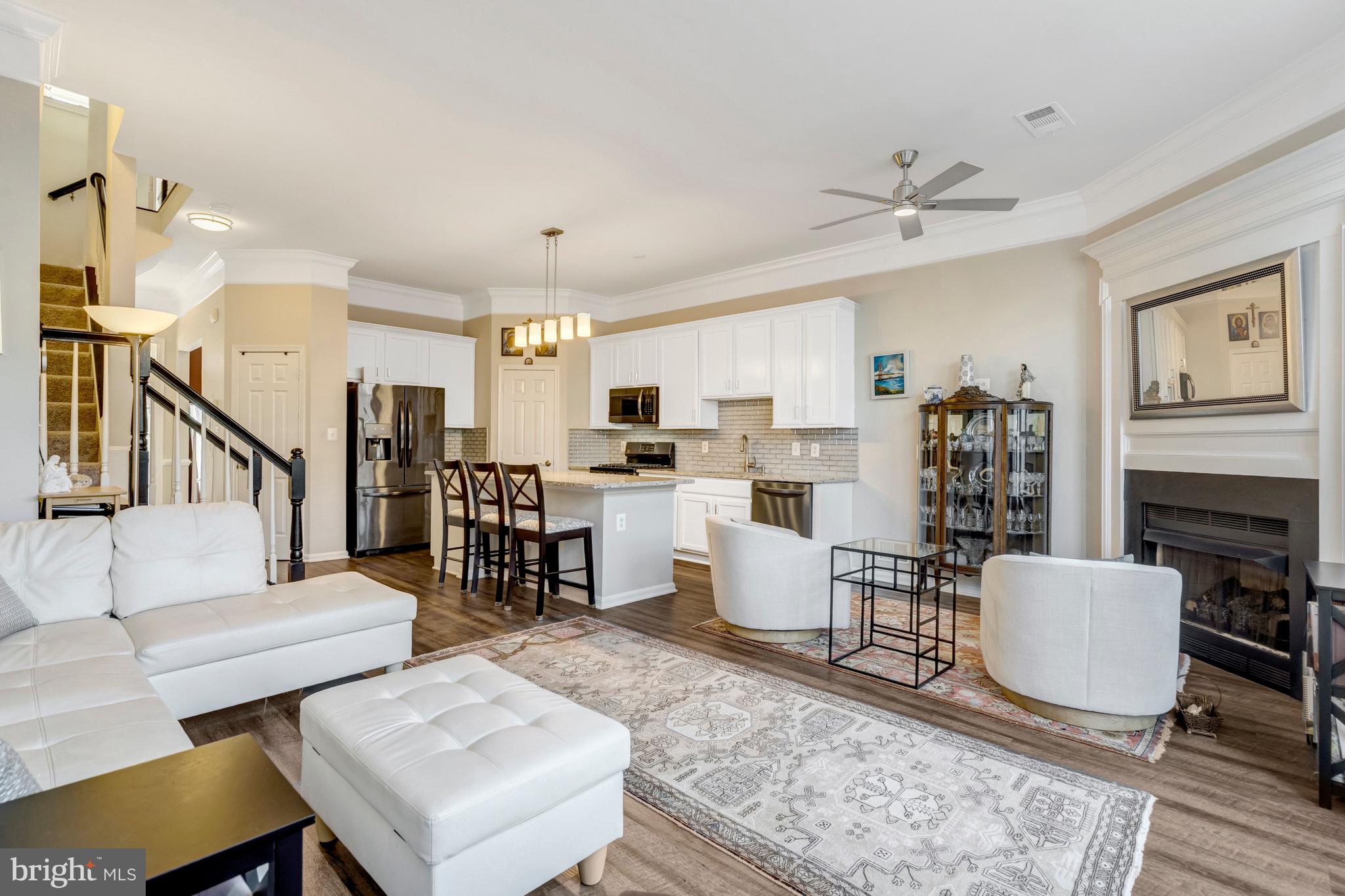 43546 Mink Meadows Street Chantilly, VA 20152 - Photo 14 of 48 a living room with furniture kitchen view and a fireplace