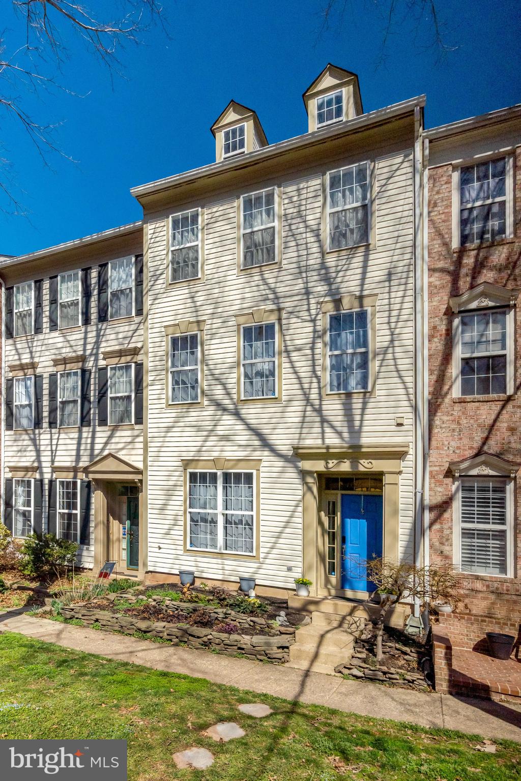 43546 Mink Meadows Street Chantilly, VA 20152 - Photo 2 of 48 a front view of a residential apartment building with a yard