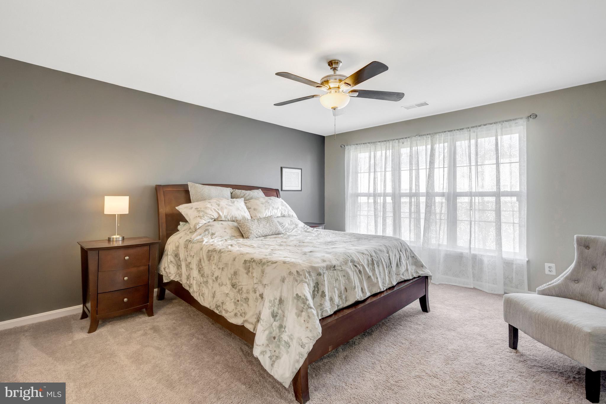 43546 Mink Meadows Street Chantilly, VA 20152 - Photo 22 of 48 a spacious bedroom with a bed and a couch