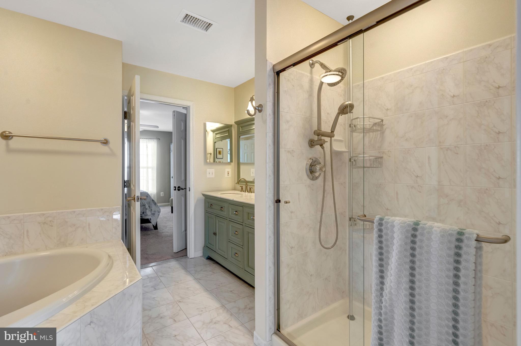 43546 Mink Meadows Street Chantilly, VA 20152 - Photo 26 of 48 a bathroom with a granite countertop shower a sink and a bathtub