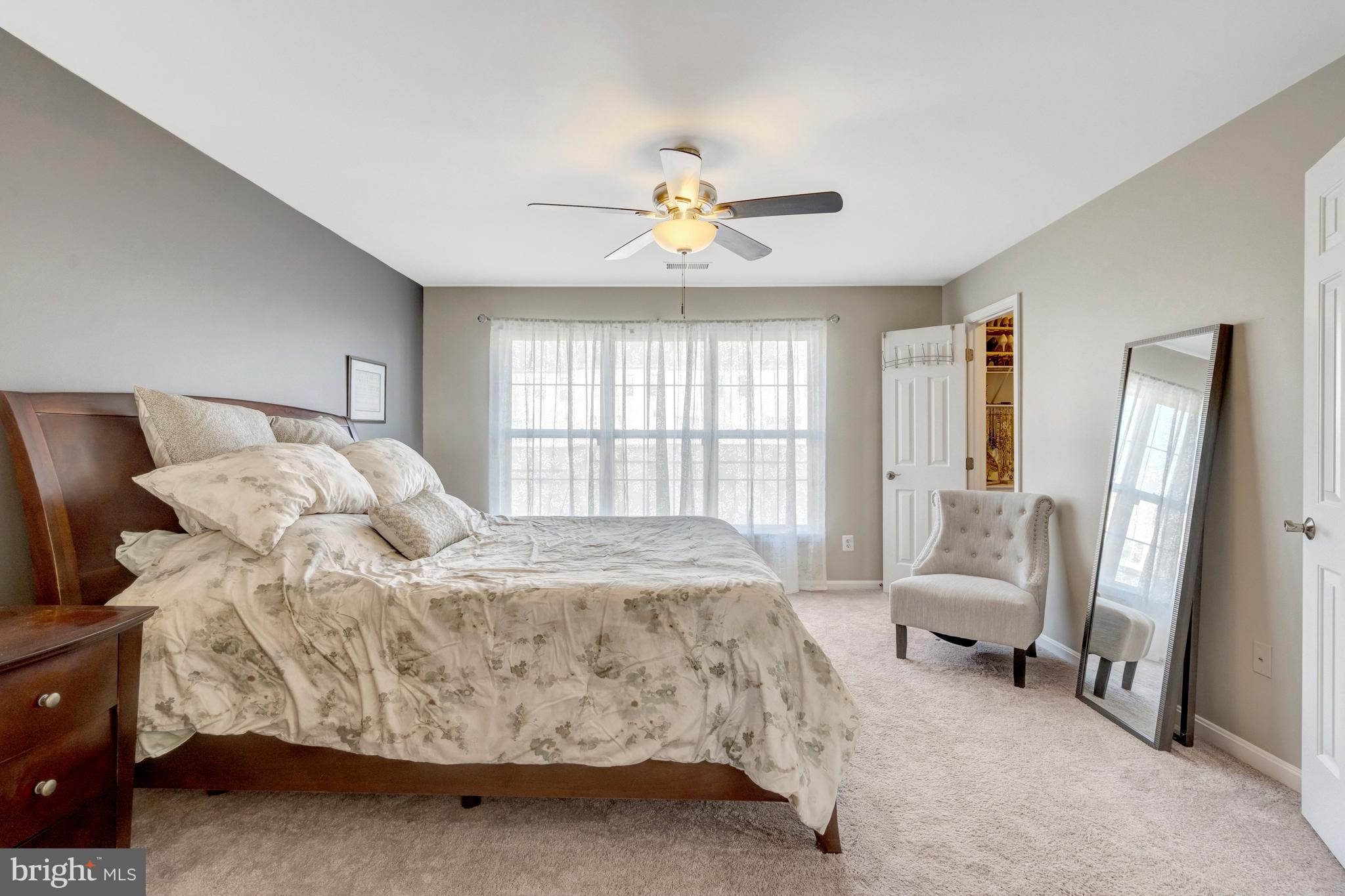 43546 Mink Meadows Street Chantilly, VA 20152 - Photo 28 of 48 a bedroom with a bed and a chandelier