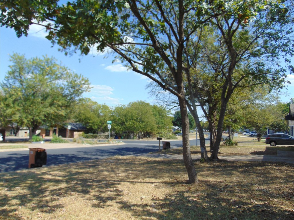 Undisclosed Address Austin, TX 78745 - Photo 2 of 9 a view of a road with houses and trees