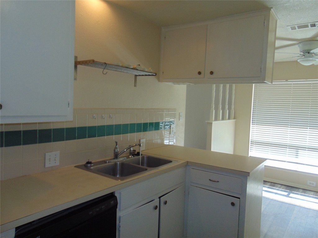 Undisclosed Address Austin, TX 78745 - Photo 4 of 9 a kitchen with a sink cabinets and window