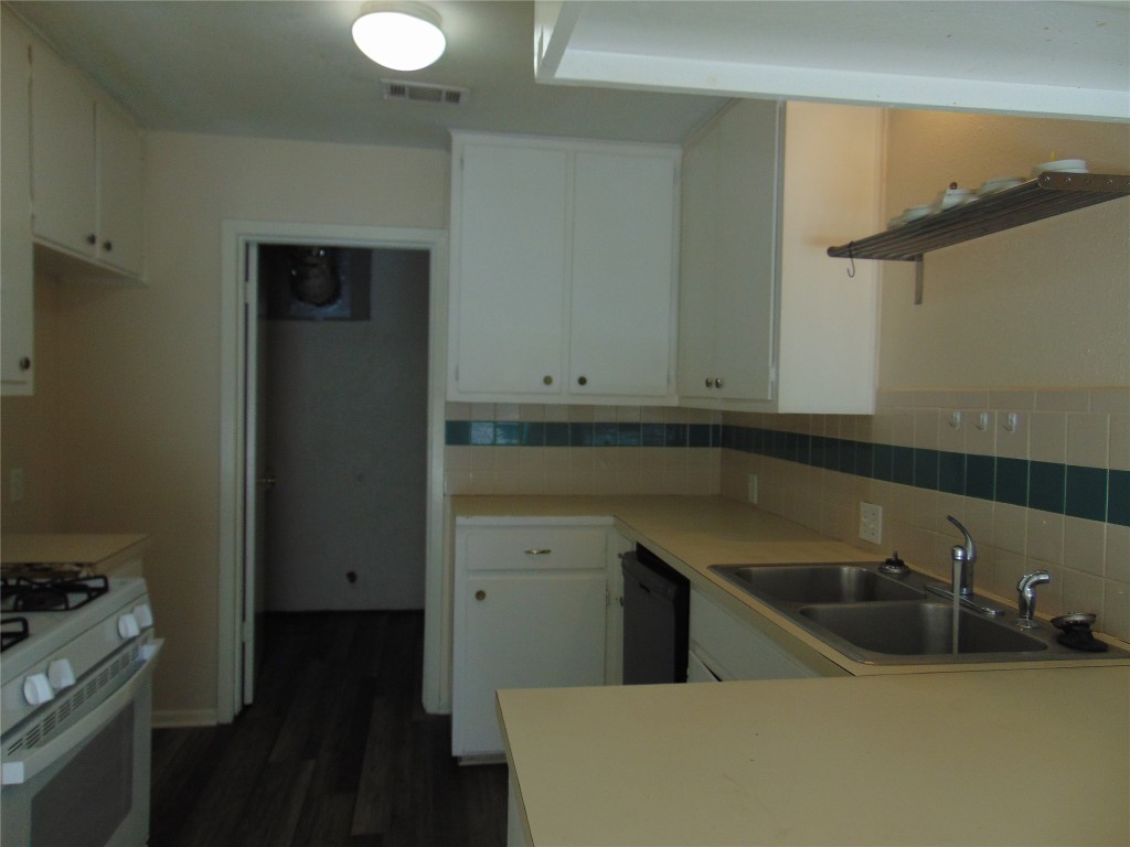 Undisclosed Address Austin, TX 78745 - Photo 5 of 9 a kitchen with a sink and cabinets