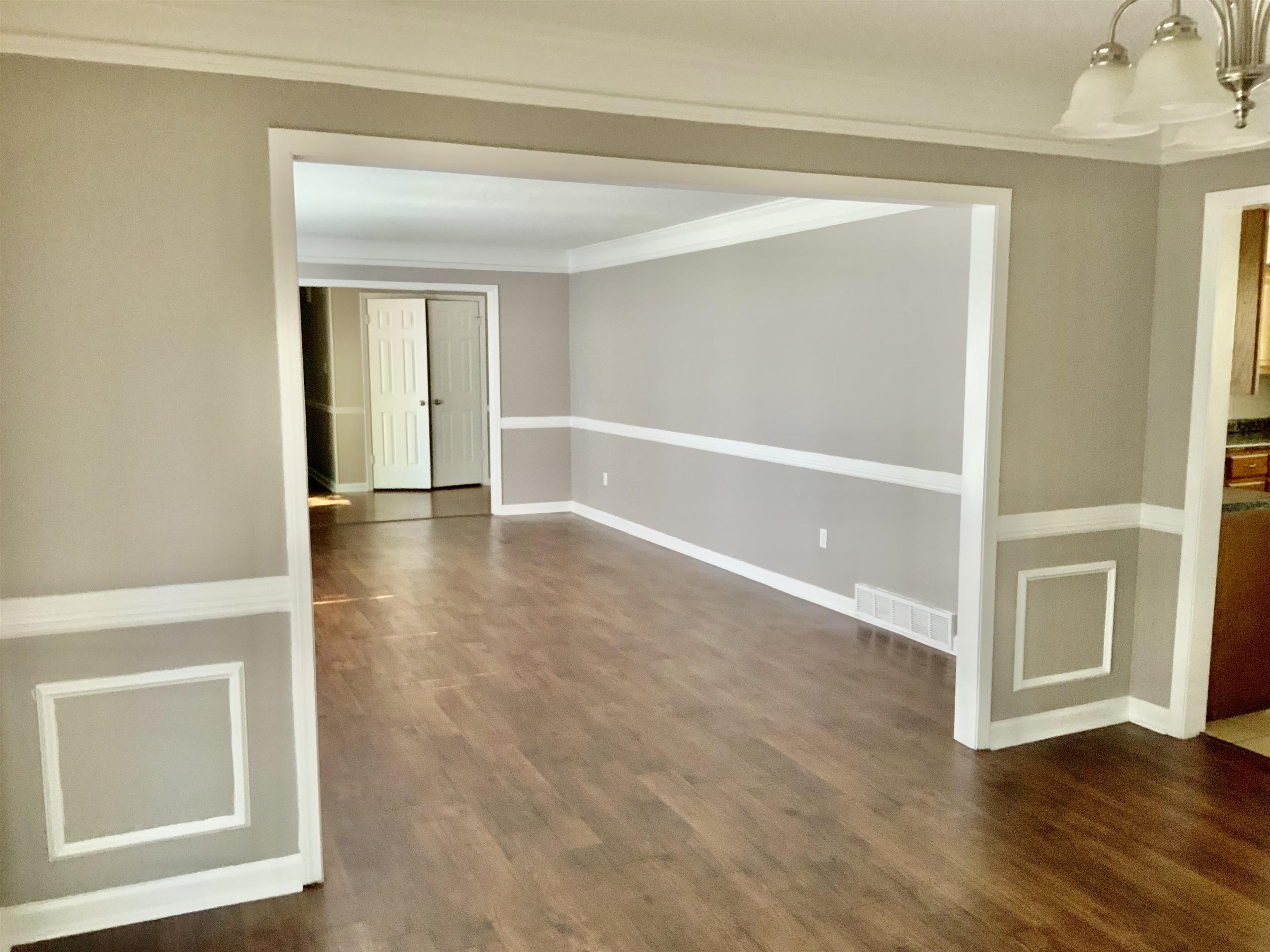 83 South Walnut Bend Road Memphis, TN 38018 - Photo 8 of 24 a view of an empty room with wooden floor and a window