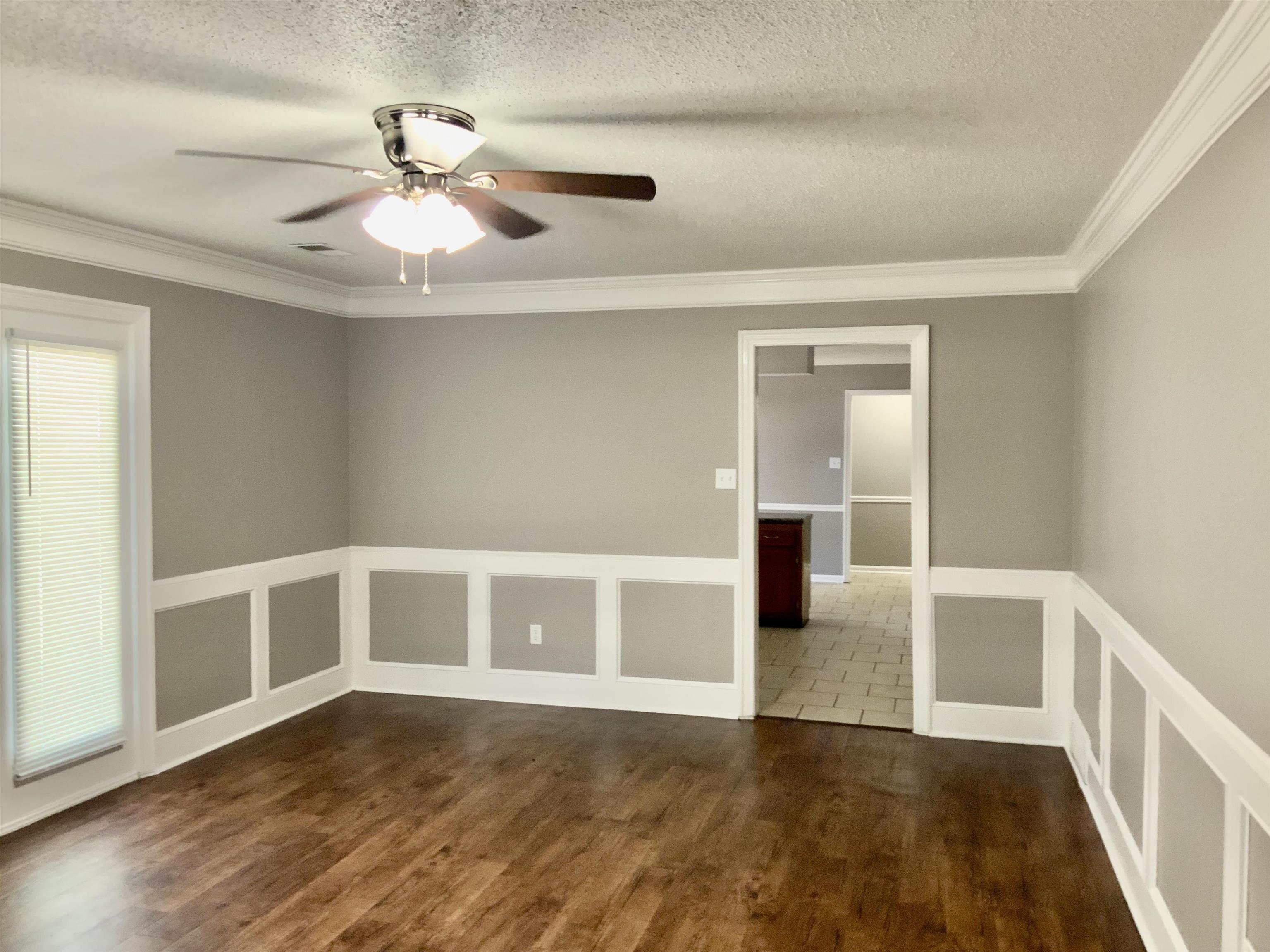 83 South Walnut Bend Road Memphis, TN 38018 - Photo 9 of 24 a view of an empty room with wooden floor and a window
