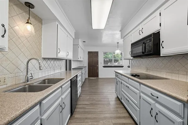 a kitchen with stainless steel appliances granite countertop a sink and a microwave