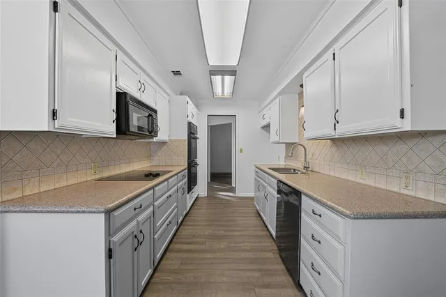 a kitchen with stainless steel appliances granite countertop a stove and a sink