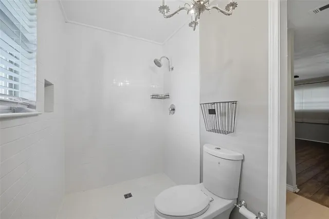 a white toilet sitting next to a bathroom sink