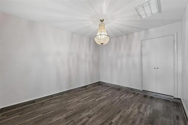 a view of a room with wooden floor and white walls