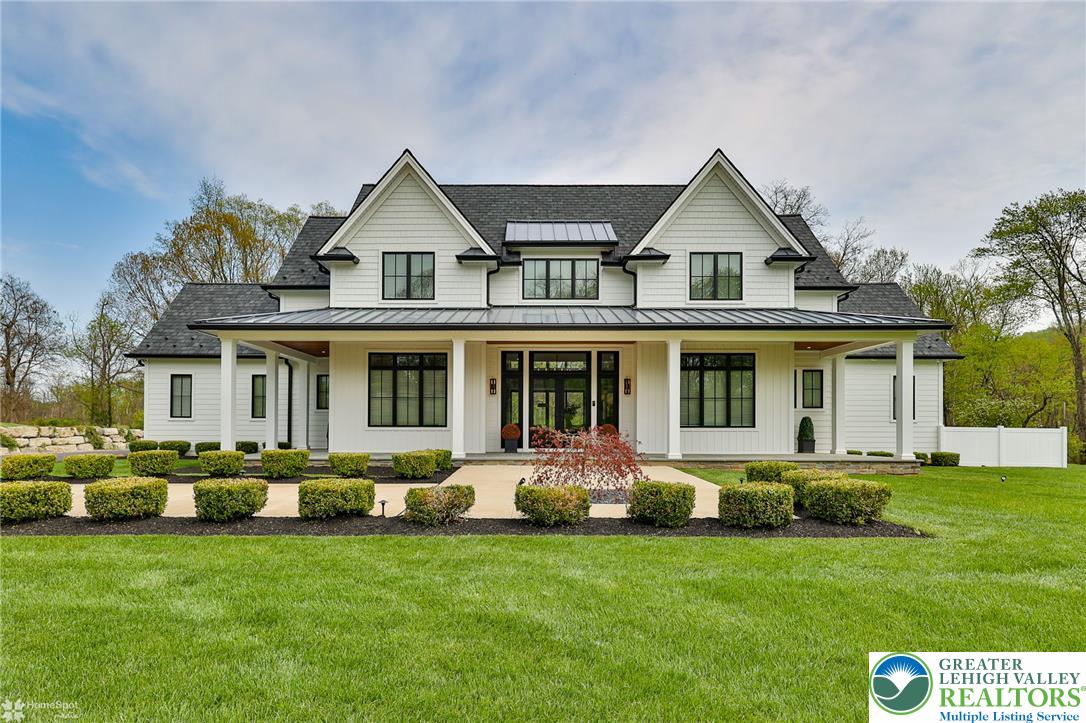 4850 West Hopewell Road Center Valley, PA 18034 - Photo 2 of 96 a front view of a house with a garden