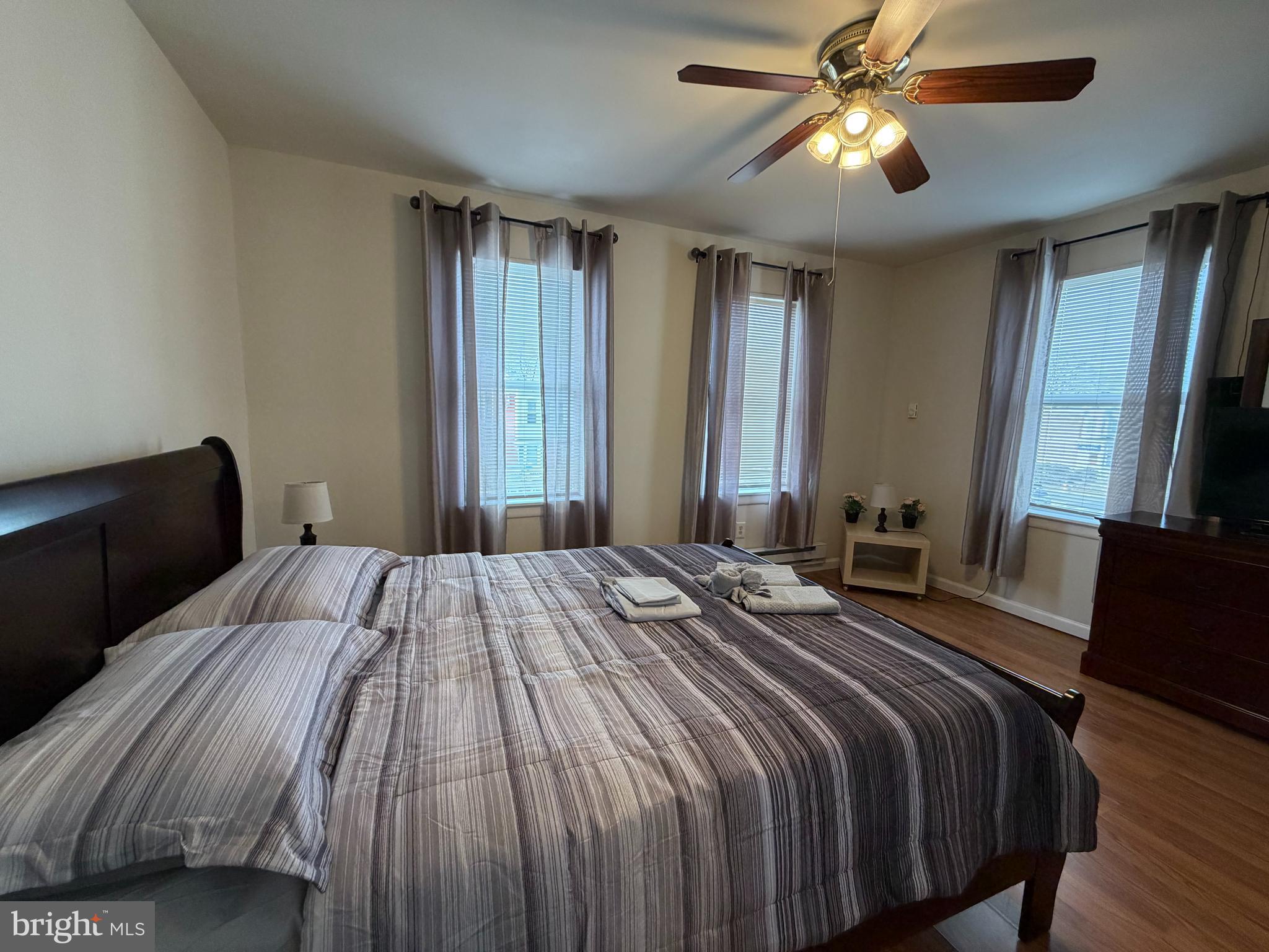7103 Rising Sun Avenue, Unit C Philadelphia, PA 19111 - Photo 11 of 19 a bedroom with a bed and a chandelier