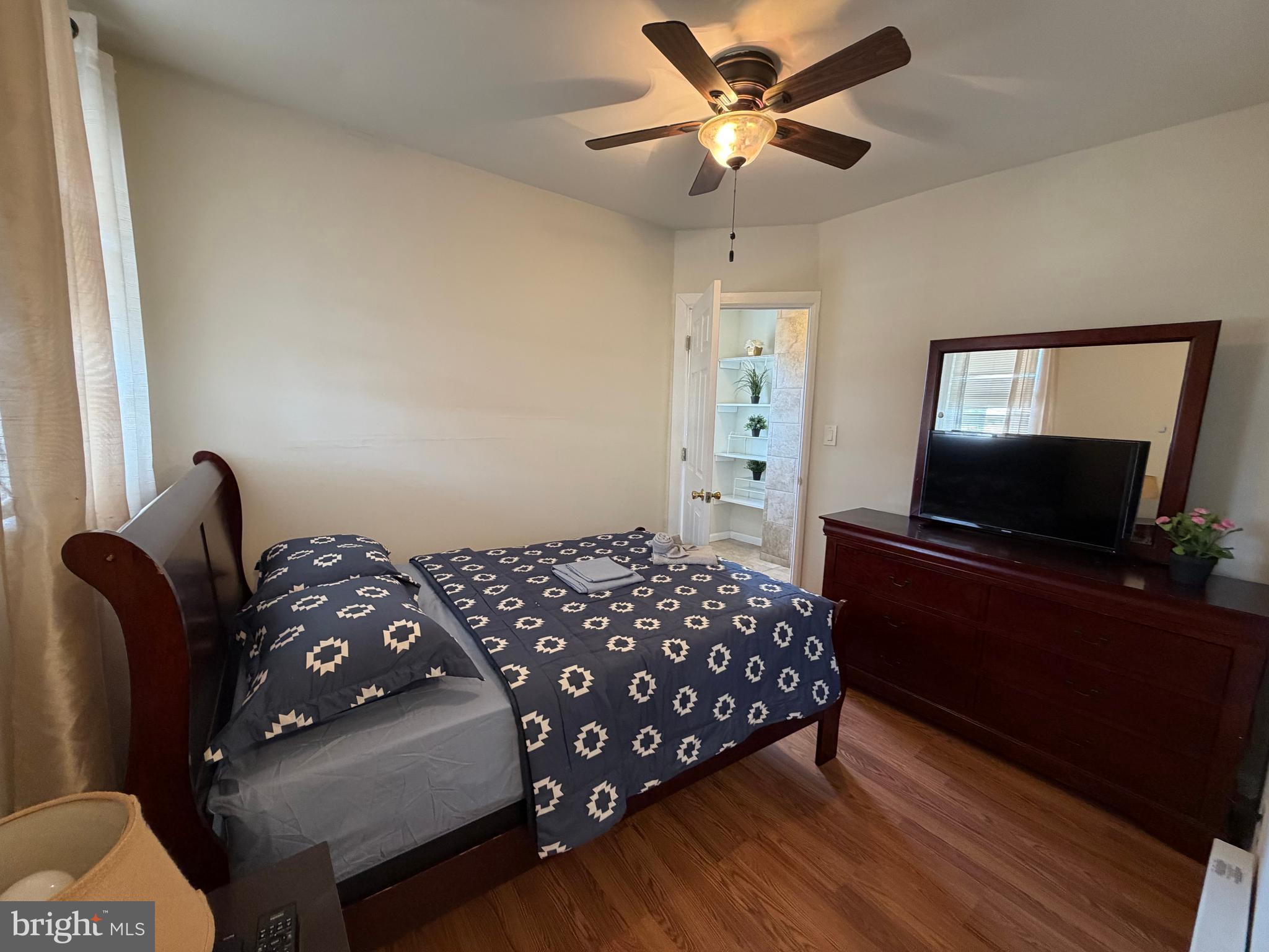 7103 Rising Sun Avenue, Unit C Philadelphia, PA 19111 - Photo 13 of 19 a bedroom with a bed and a television