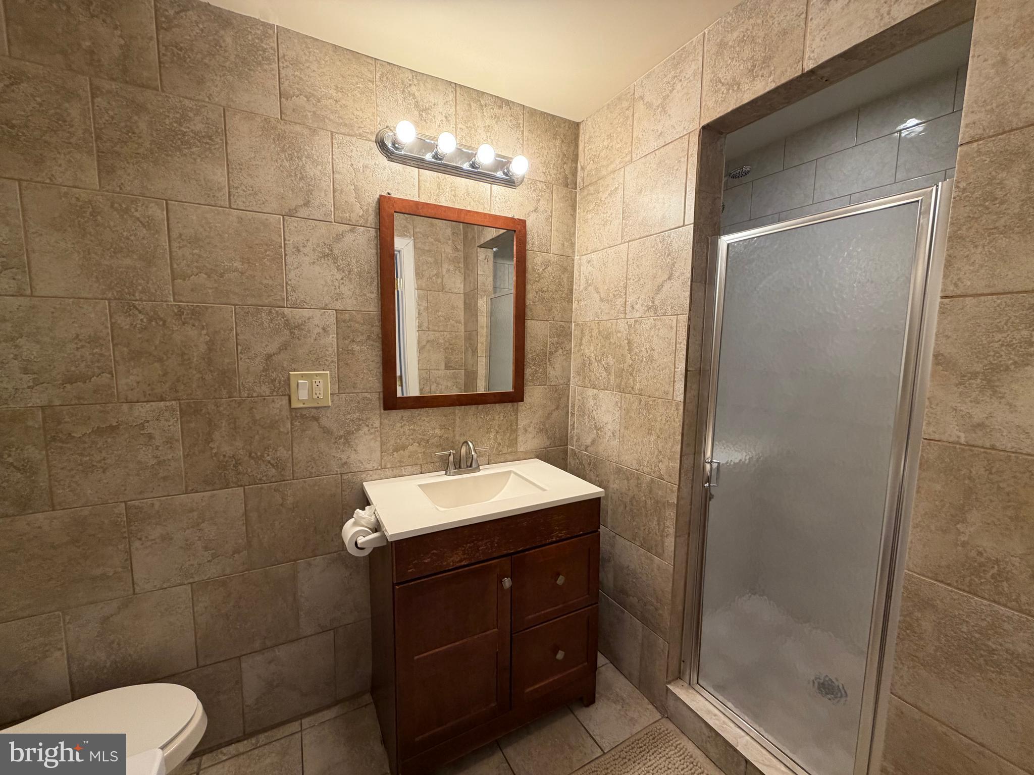 7103 Rising Sun Avenue, Unit C Philadelphia, PA 19111 - Photo 17 of 19 a bathroom with a sink a toilet and shower