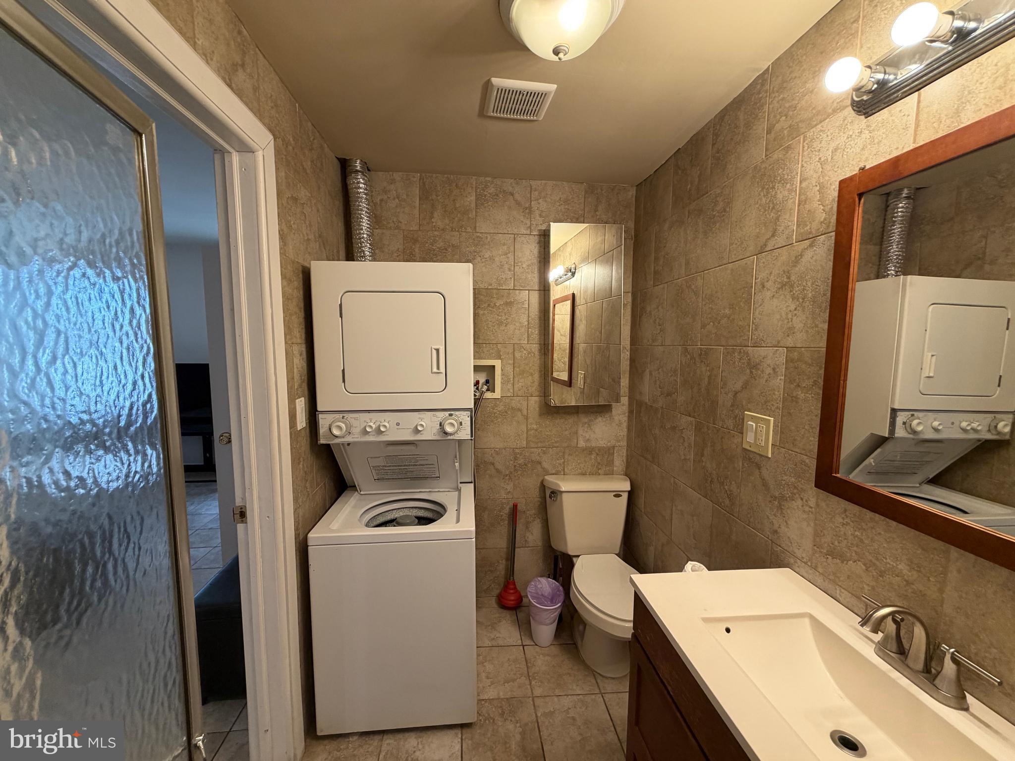 7103 Rising Sun Avenue, Unit C Philadelphia, PA 19111 - Photo 19 of 19 a bathroom with a sink a toilet and mirror